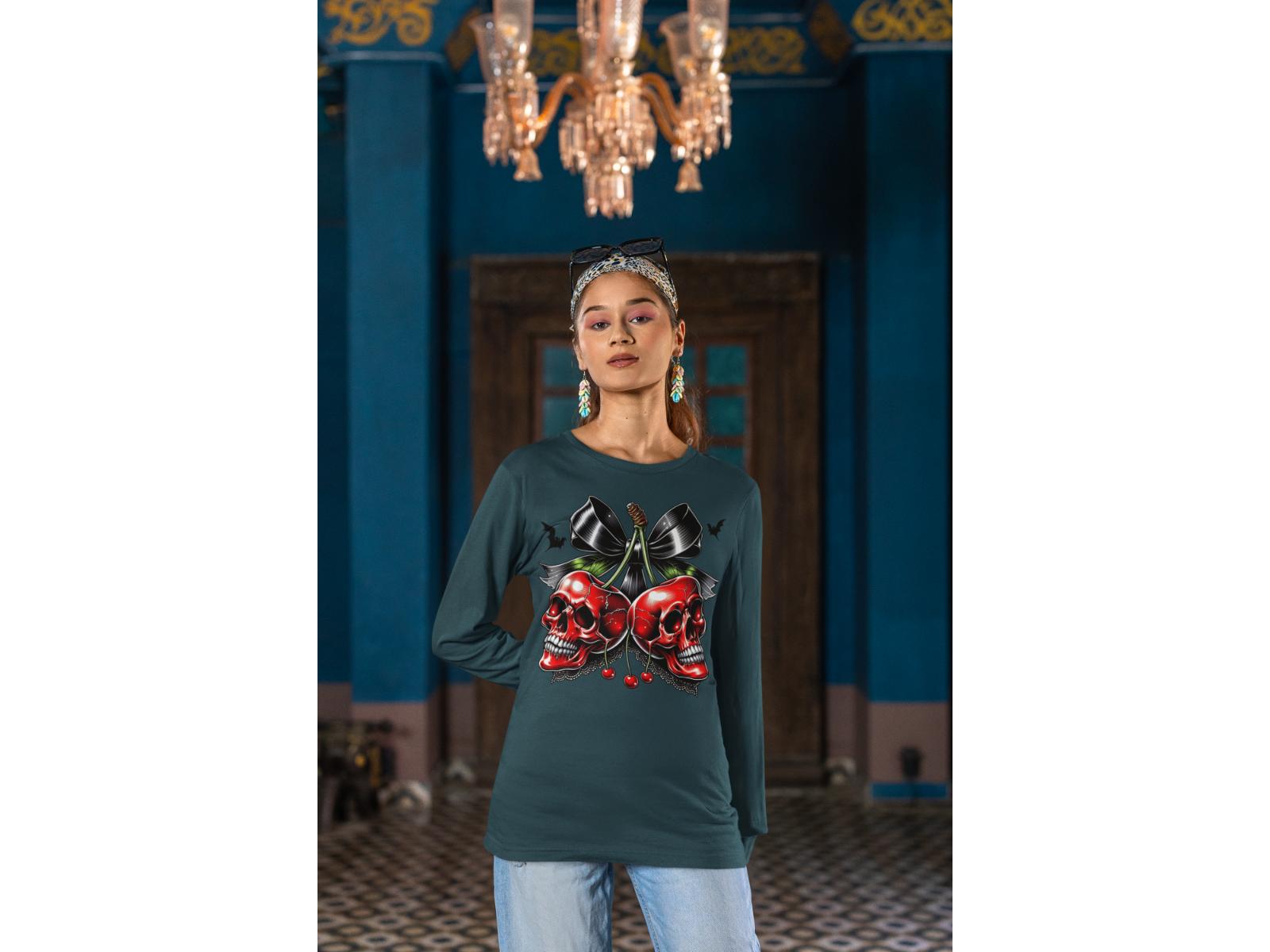 A woman wears a dark green long-sleeve shirt with a red skull and cherry design.