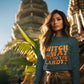 A woman wears a dark blue "Witch Way to the Candy" Halloween sweatshirt.