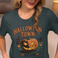 A woman in a baseball cap wears a dark green Halloween Town t-shirt.