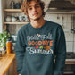 A man wears a dark teal "Hello Fall GOODBYE Summer" sweatshirt with autumn leaves.