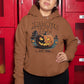A woman wears a brown Halloween Town hoodie with a vintage pumpkin graphic.