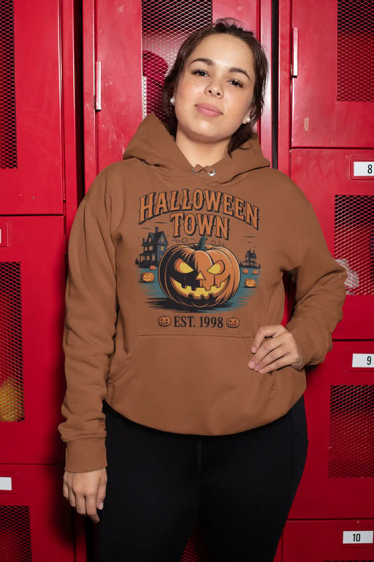 A woman wears a brown Halloween Town hoodie with a vintage pumpkin graphic.