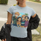 A woman wears a light blue t-shirt featuring four anime characters.