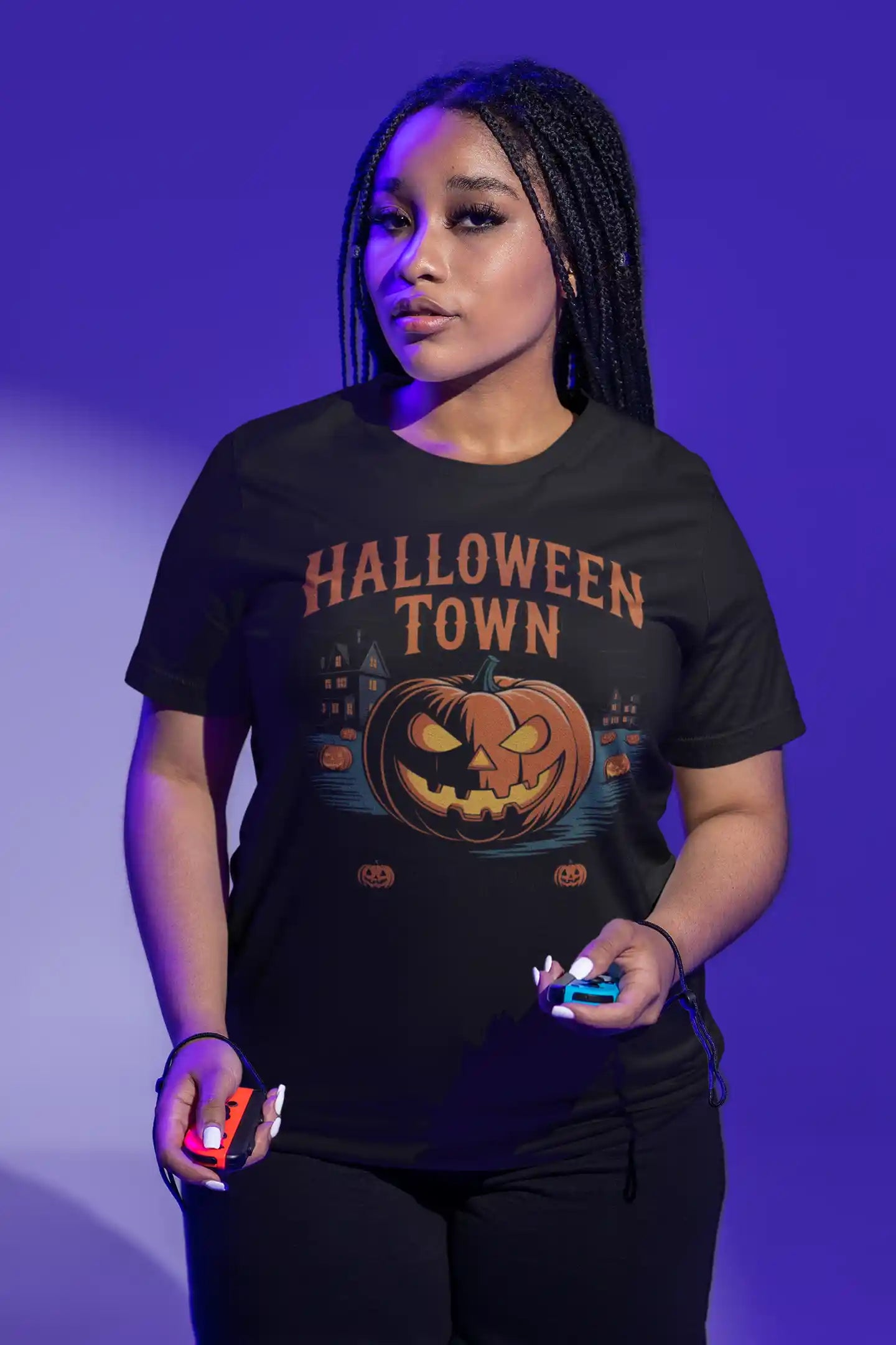 A person wears a black t-shirt with a "Halloween Town" pumpkin graphic.