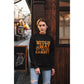 A woman wears a black "Witch Way to the Candy" Halloween sweatshirt.