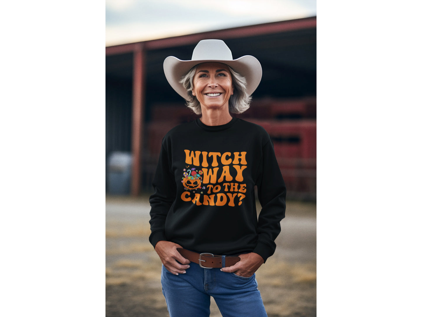 A woman in a cowboy hat wears a black "Witch Way to the Candy?" Halloween sweatshirt.