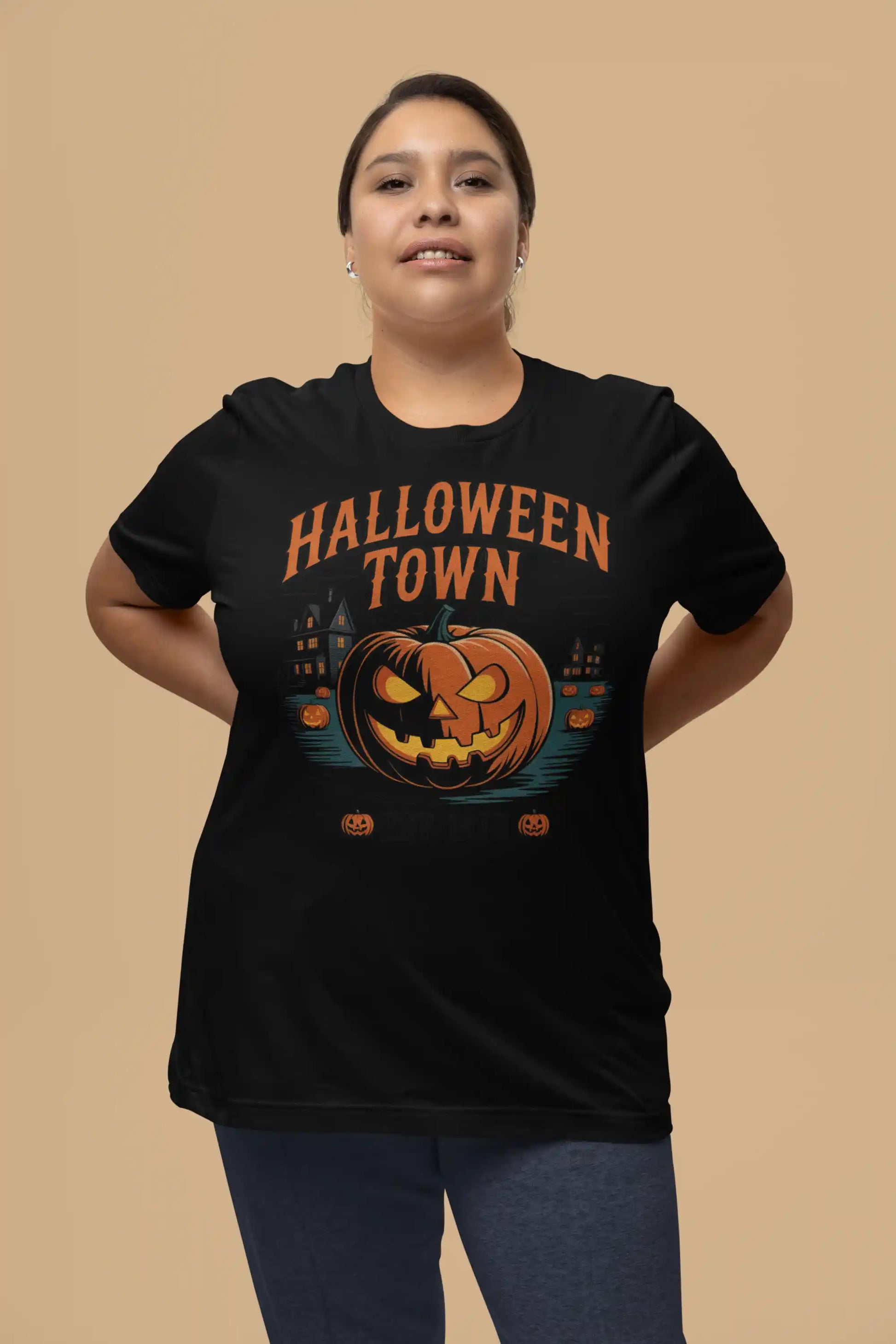 A woman wears a black Halloween Town t-shirt with a vintage pumpkin graphic.