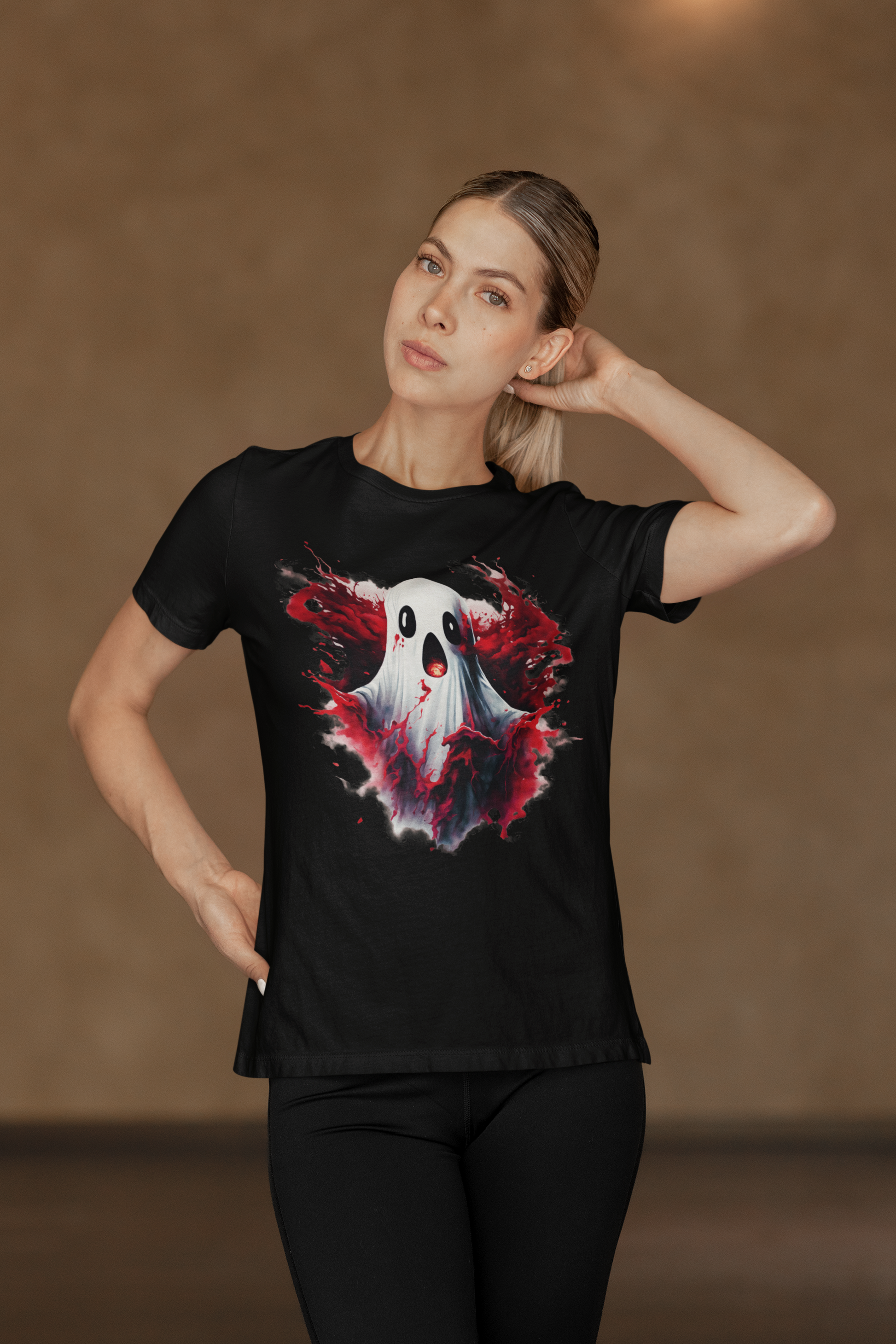 A woman models a black t-shirt with a creepy Halloween ghost design.