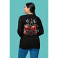 A woman from behind wears a black long-sleeve shirt with a cherry skull design.
