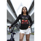 A woman wears a black long-sleeve shirt with a spooky cherry Halloween bow design.