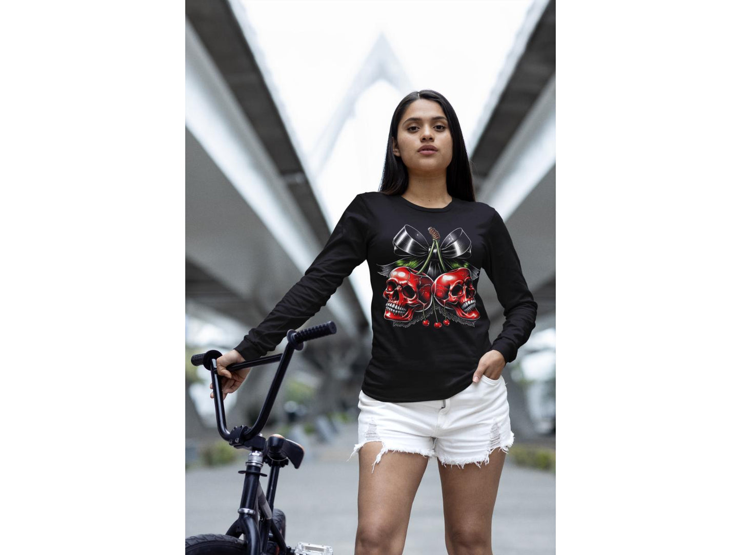 A woman wears a black long-sleeve shirt with a spooky cherry Halloween bow design.