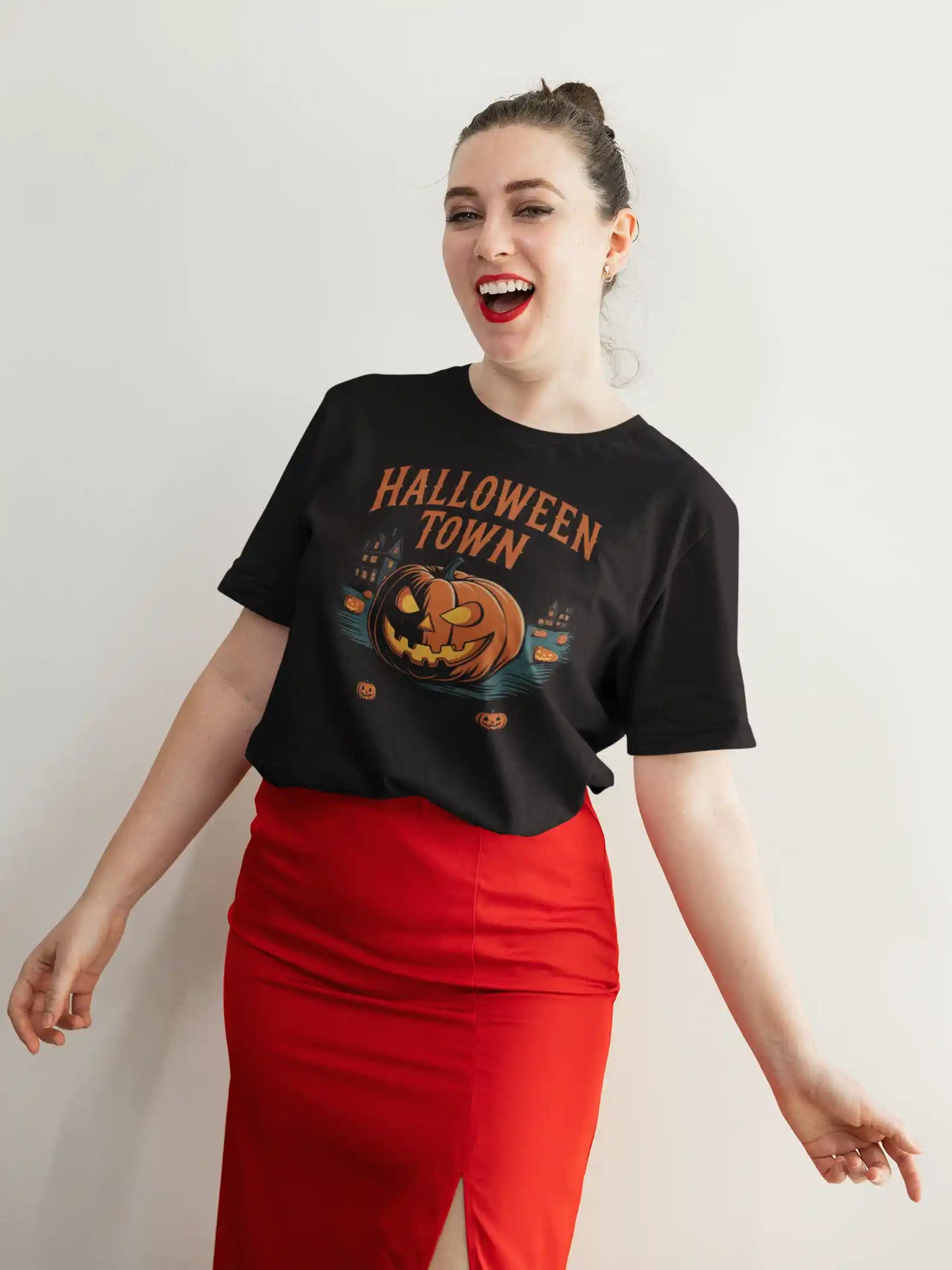 A woman in a black Halloween Town t-shirt and red skirt smiles at the camera.