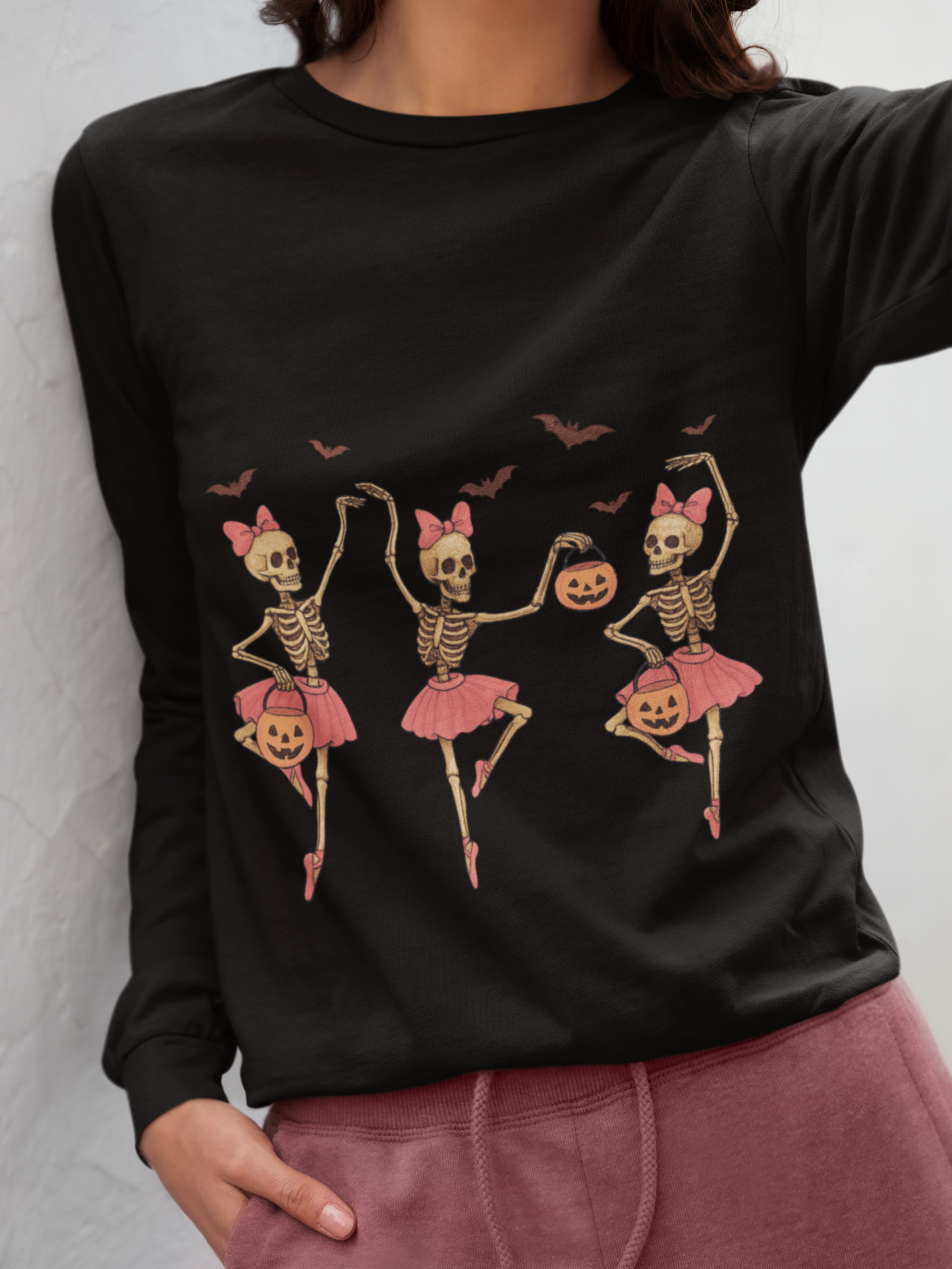 Black long sleeve shirt with three dancing skeleton ballerinas and bats.
