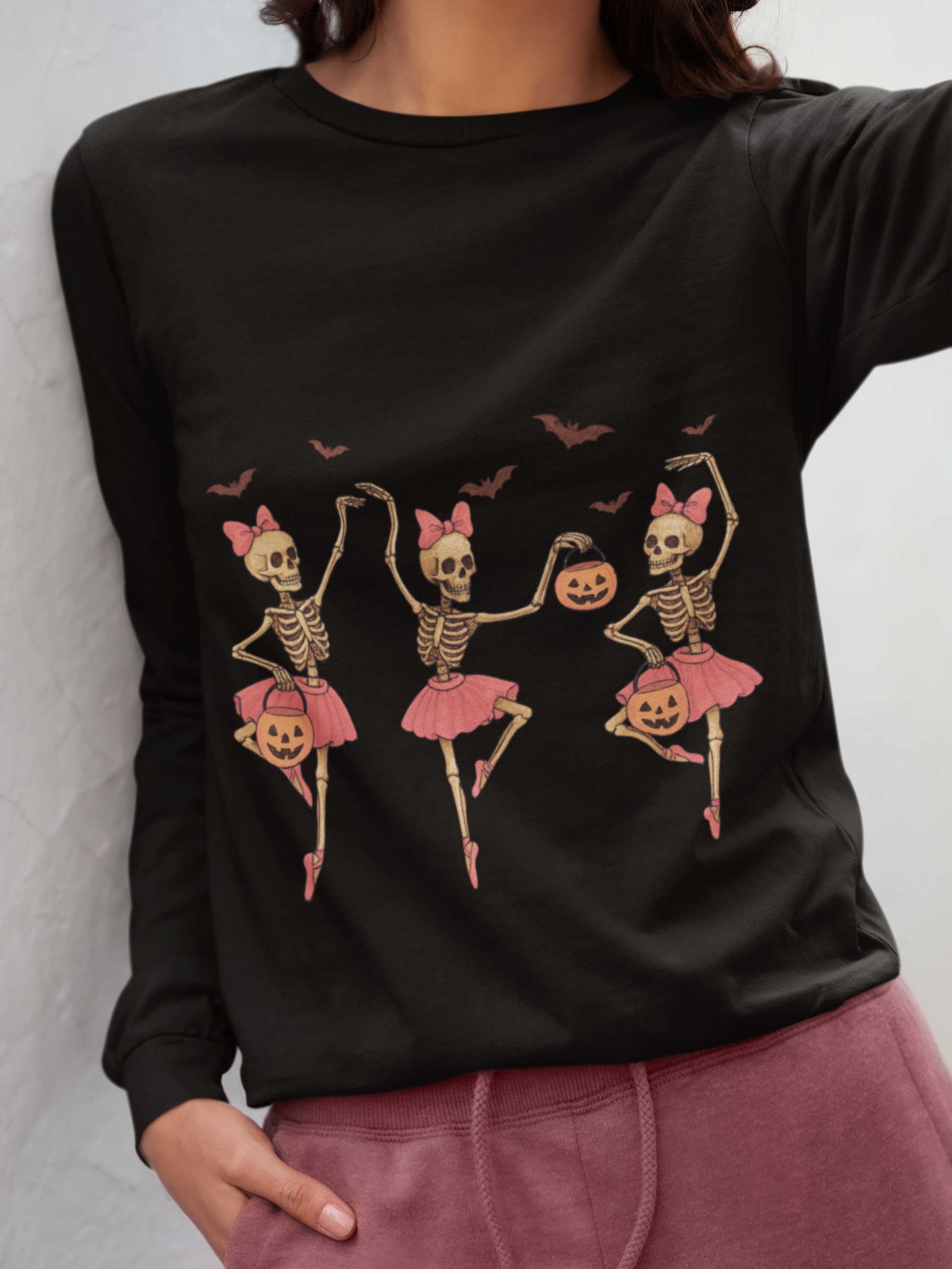 Black long sleeve shirt with three dancing skeleton ballerinas and bats.