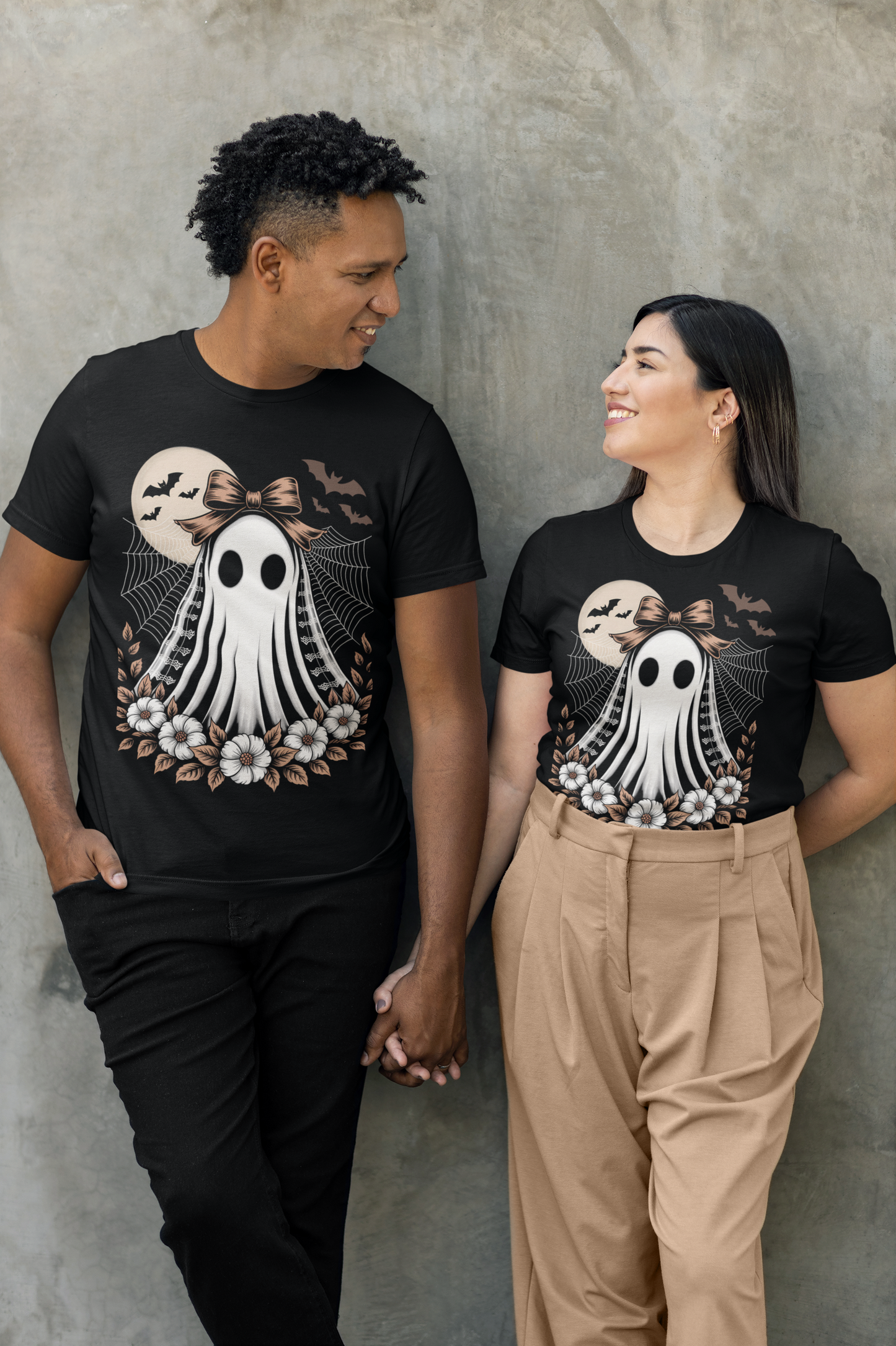 Two people wear black t-shirts with a vintage lace ghost design.