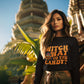 A woman wears a black "Witch Way to the Candy" Halloween sweatshirt.