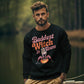 A man wears a black sweatshirt with "Baddest Witch in Town" and a witch graphic.