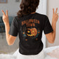 A person from behind wears a black Halloween Town t-shirt with a pumpkin graphic.