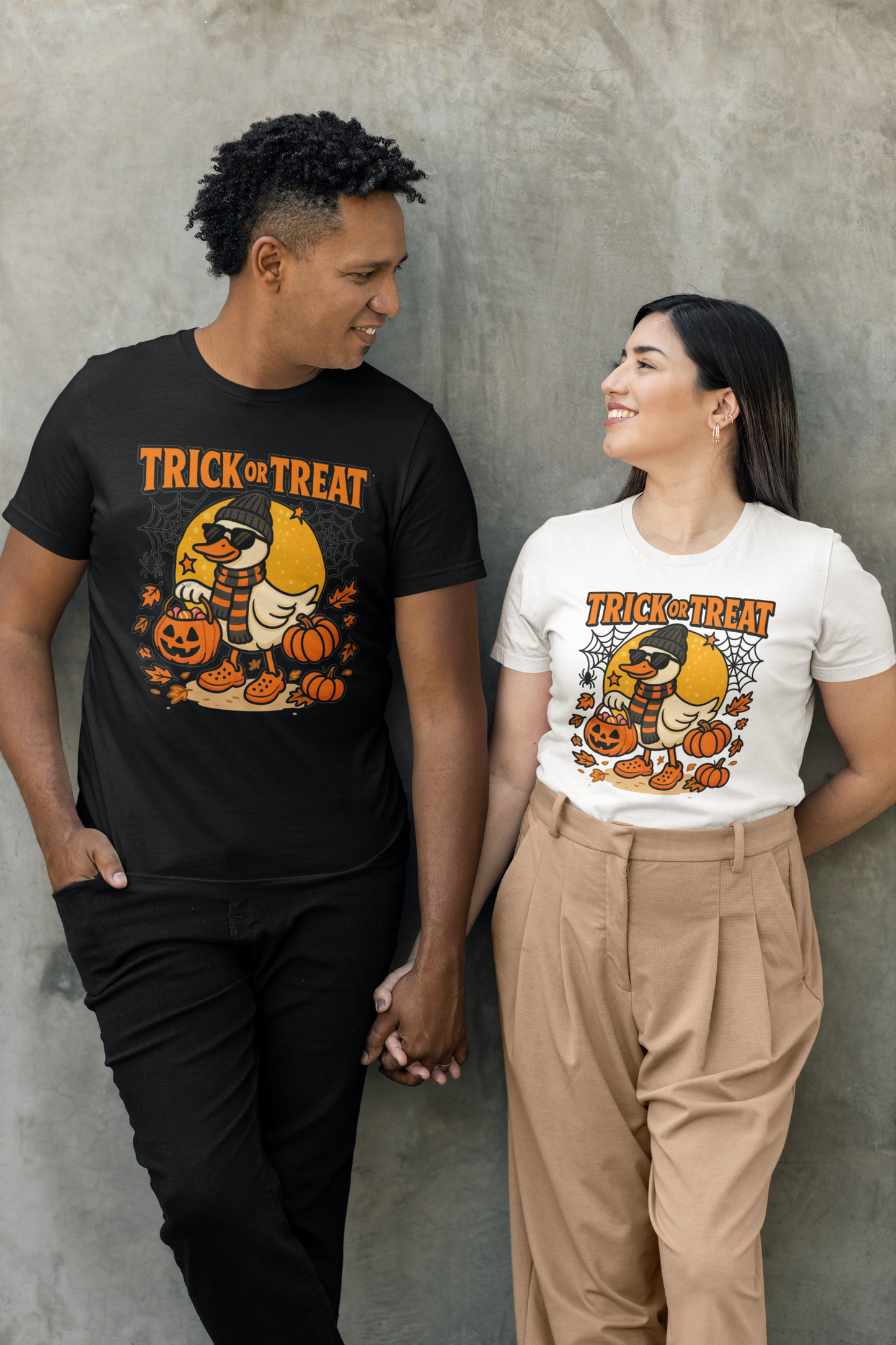 A couple wearing matching Halloween duck "Trick or Treat" t-shirts.