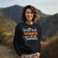 A woman smiles while wearing a black "Hello Fall Goodbye Summer" sweatshirt.