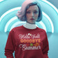 A woman in a red "Hello Fall GOODBYE Summer" sweatshirt stands against a blue background.
