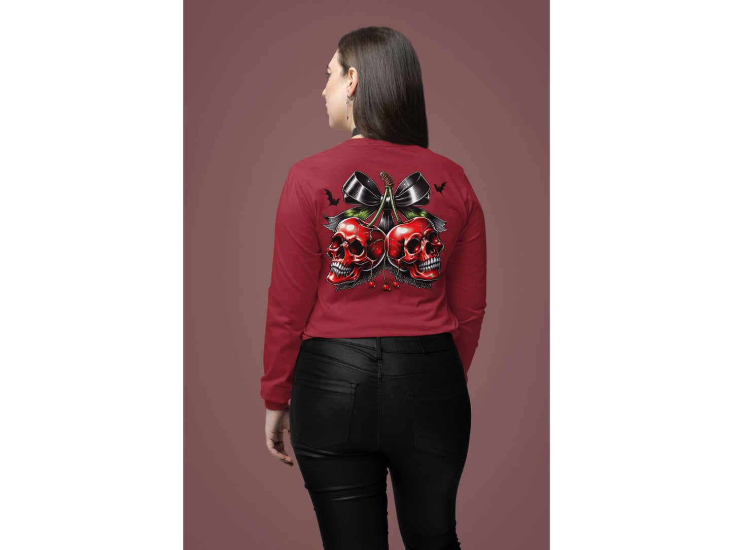 A woman from behind wears a red long-sleeve shirt with a spooky cherry and bow design.