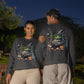 Two people wear dark gray long-sleeve sweatshirts with a Halloween graphic.