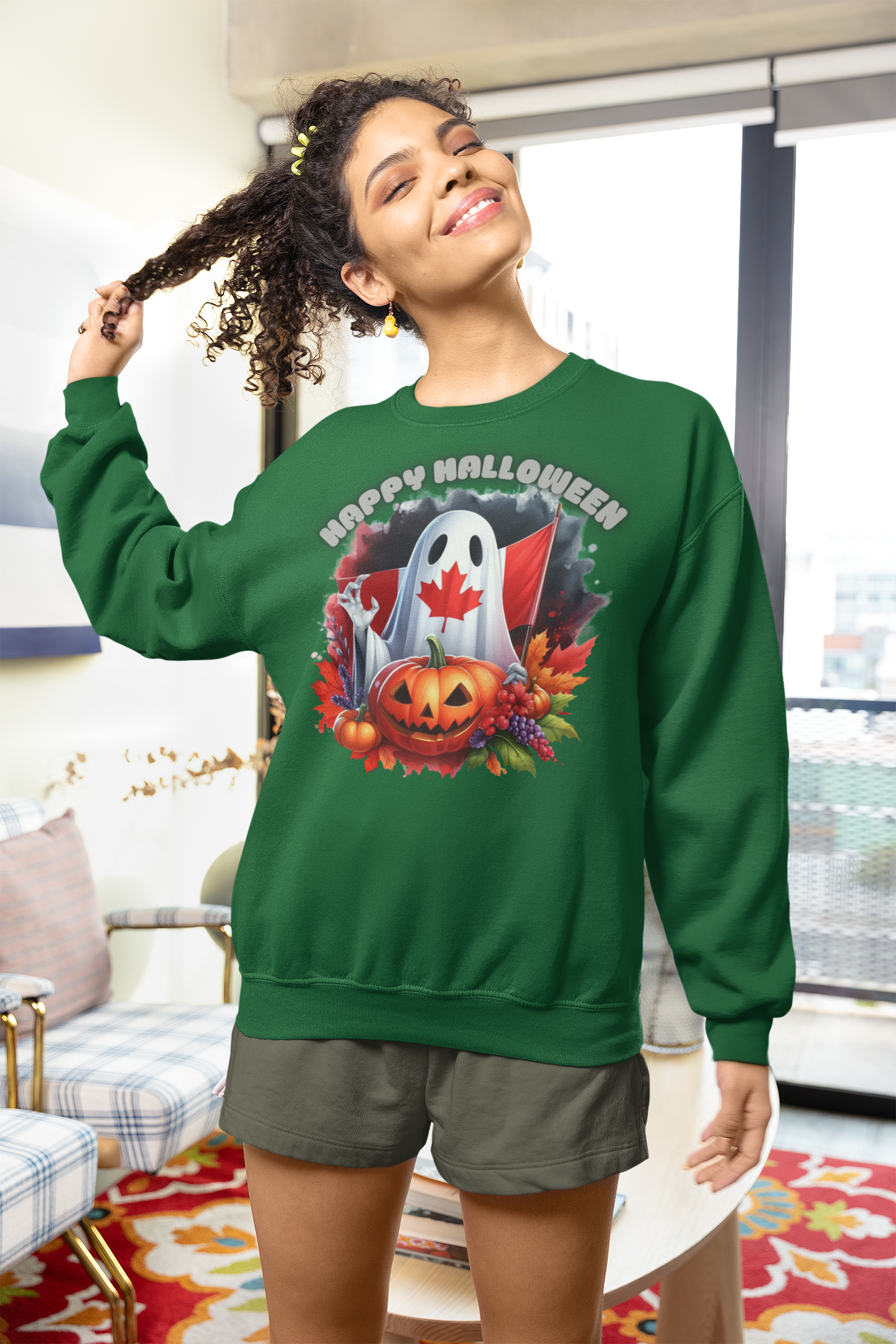 A woman wears a green sweatshirt with a Canadian Halloween ghost and pumpkin design.