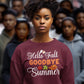A woman wears a maroon "Hello Fall GOODBYE Summer" sweatshirt with autumn leaf graphics.