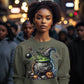 A woman wears a green sweatshirt with a Happy Halloween witch cauldron design.