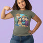 A woman wears a green t-shirt featuring an anime-style illustration of four friends.