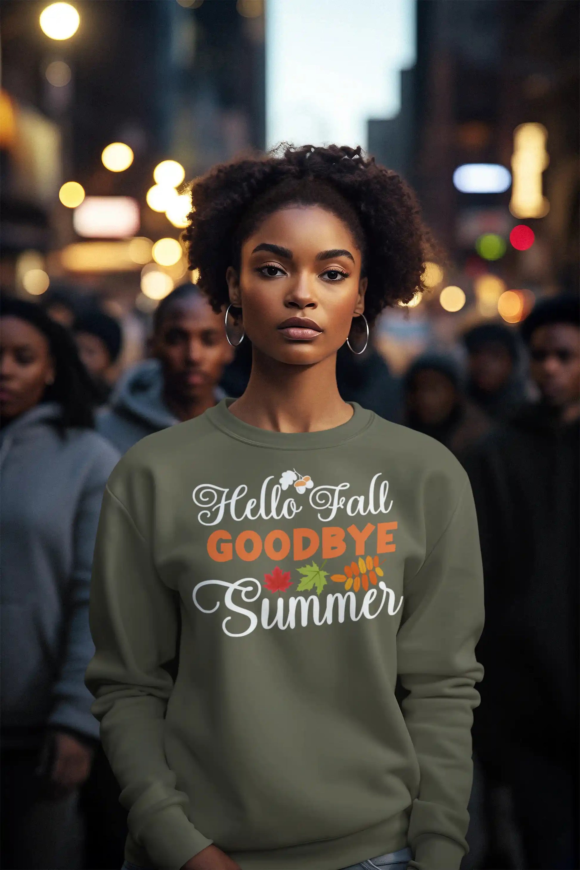 A woman wears an olive green sweatshirt with "Hello Fall GOODBYE Summer" text.