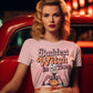 Baddest Witch in Town Retro Halloween T-Shirt on a woman in a red car.