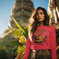 A woman wears a pink Halloween Town sweatshirt with a pumpkin graphic.