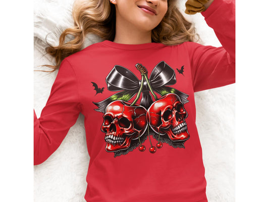 A woman wears a red long-sleeve shirt with a spooky cherry and skull design.