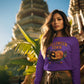 A woman wears a purple Halloween Town sweatshirt with a vintage pumpkin graphic.