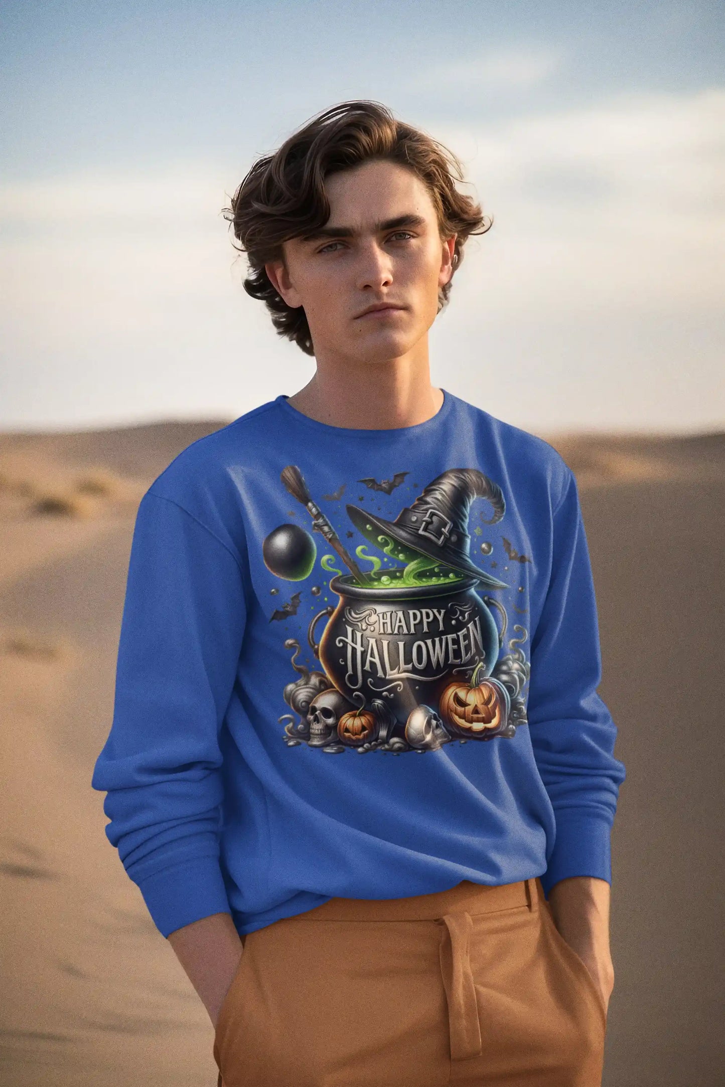A man in a blue "Happy Halloween" sweatshirt stands in a desert landscape.