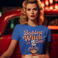 A woman in a blue "Baddest Witch in Town" t-shirt sits in a red car.