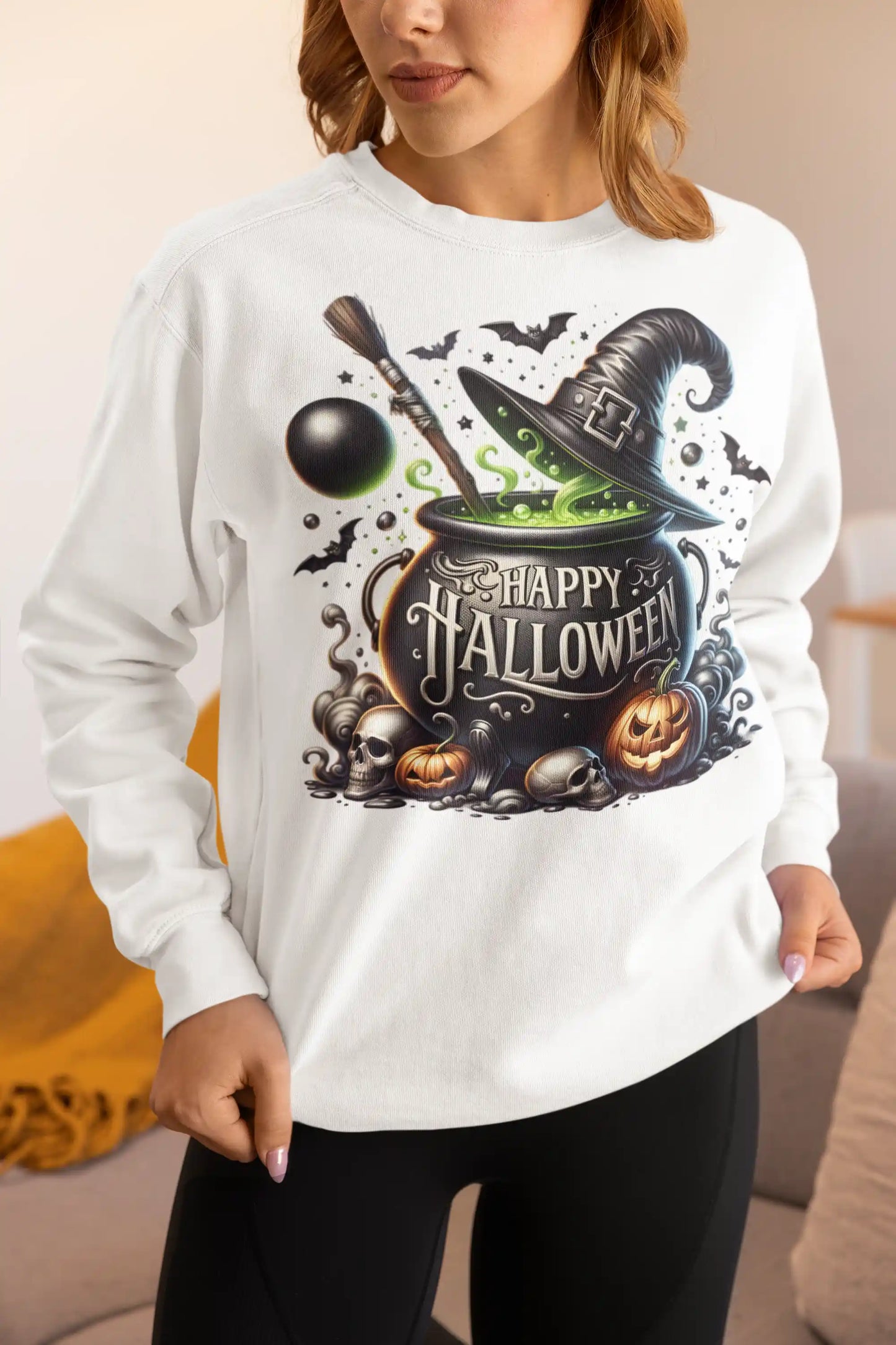 A woman wears a white sweatshirt with a "Happy Halloween" witch's cauldron design.