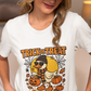 A woman in a beige cap and white t-shirt with a Halloween duck graphic.