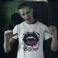 A man in vampire makeup points to a white t-shirt with a "Bite Me" design.