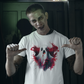 A zombie-like man points to a white t-shirt with a ghost and red splatters.