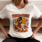 A woman wears a white t-shirt with a Halloween duck graphic.