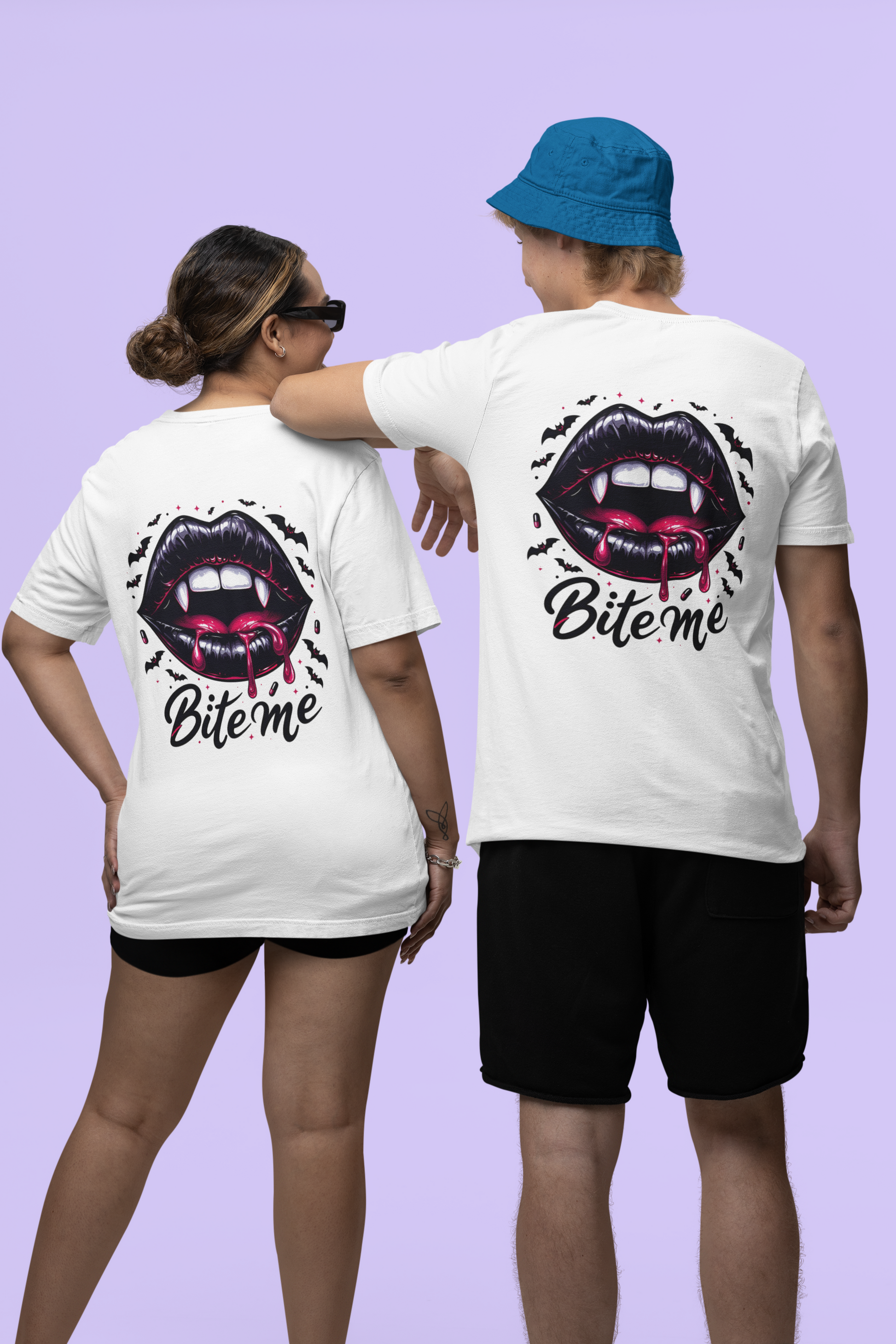 Two people wear white t-shirts with a gothic vampire lips design on the back.