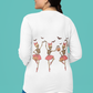 A woman from behind wears a white long-sleeve shirt with dancing skeleton ballerinas.