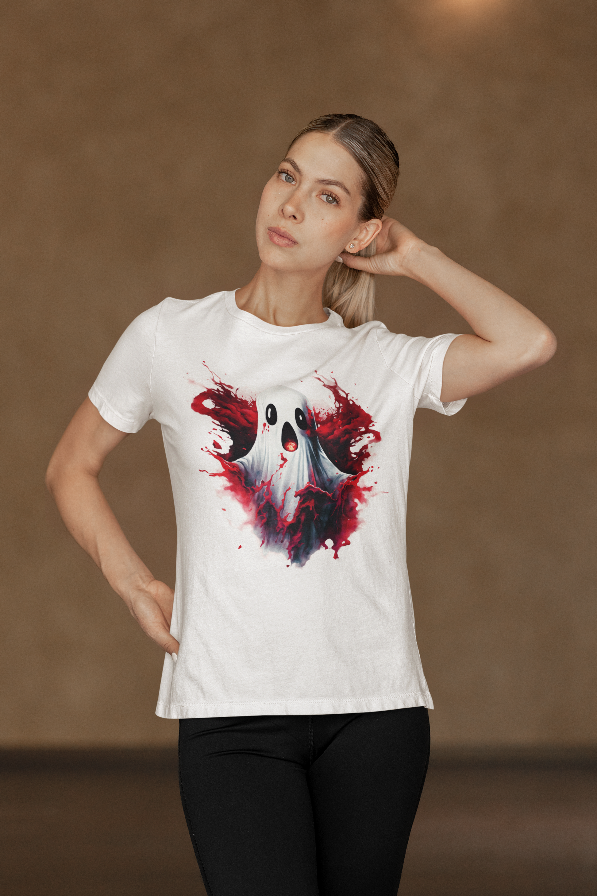 A woman wears a white t-shirt with a creepy Halloween ghost design.
