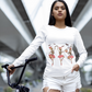 Woman in white long-sleeve shirt with dancing skeleton ballerinas and bats.