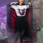 A woman in a vampire costume wears a white t-shirt with a ghost design.