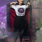 A woman in a vampire costume wears a white t-shirt with a "Bite Me" graphic.