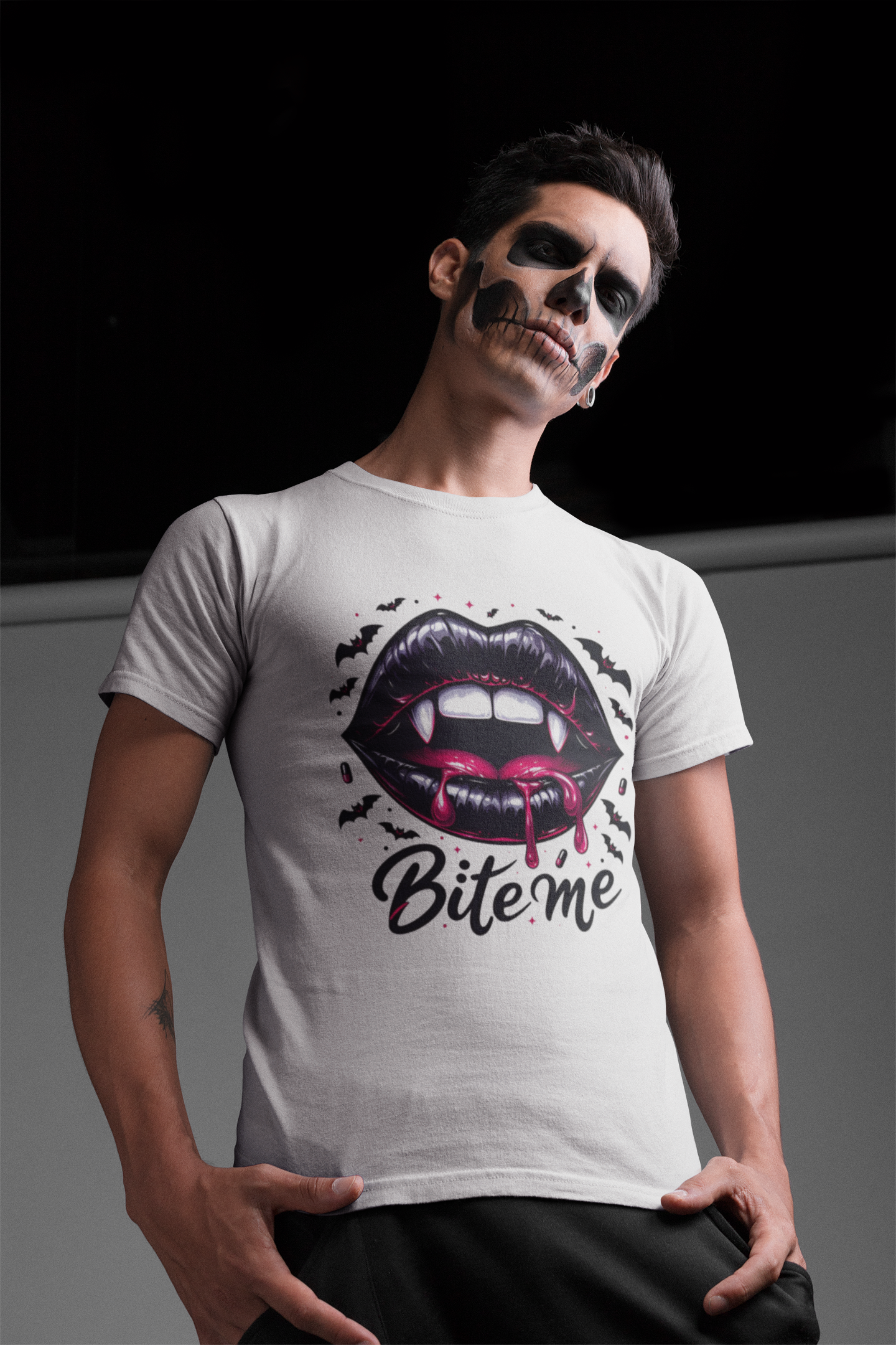 A man in skull makeup wears a white t-shirt with a "Bite me" vampire lips graphic.